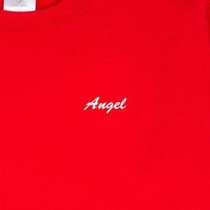 "Angel" embroidered in blanc thread on a red sweatshirt: front-on close-up