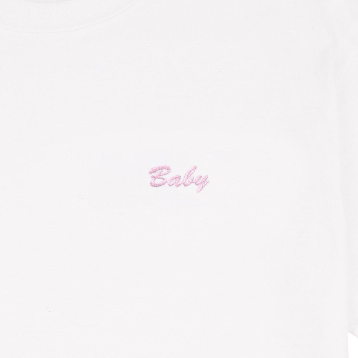 "Baby" embroidered in rose-pink thread on a white tee: front-on close-up